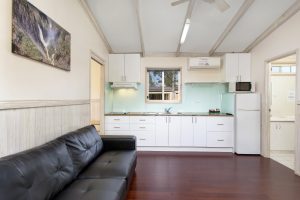 Kitchen with full sized fridge in 2 bedroom cabin