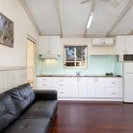 Kitchen with full sized fridge in 2 bedroom cabin